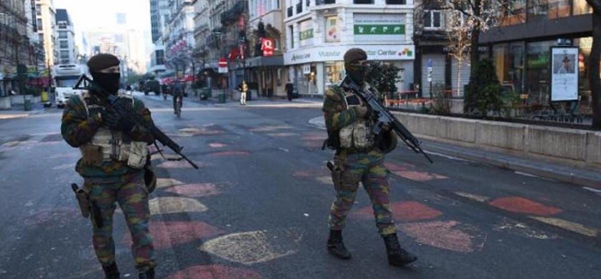 Brussels still on terror alert, fourth suspect in Paris attacks charged